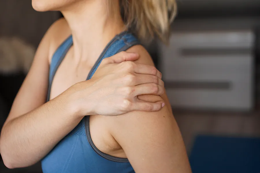 Chronic-Inflammation-Clinic A woman massages her sore shoulder. Get chronic inflammation treatment from Dr. Stephanie King in Salt Lake City.