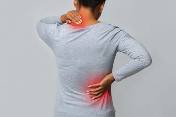 Fibromyalgia-Clinic An image from behind of a woman suffering from Fibromyalgia holding her hands on her neck and lower back. Get fibromyalgia care from Dr. Stephanie King in Salt Lake City.