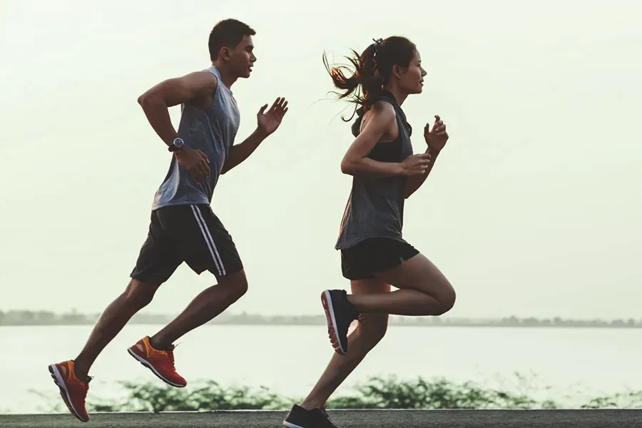 GLP-1-Weight-Loss-Injections-Clinic A couple in profile running along the water. Schedule GLP-1 Weight Loss Injections from Dr. Stephanie King in Salt Lake City.