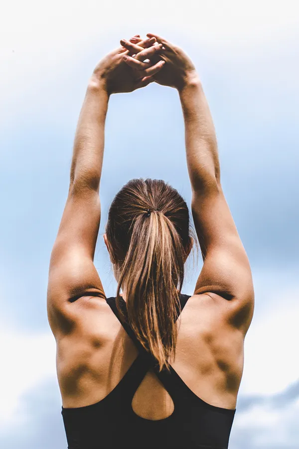 GLP-1-Weight-Loss-Injections-Treatment A toned woman seen from behind stretching her arms into the air. Get GLP-1 Weight Loss Injections from Dr. Stephanie King in Salt Lake City.