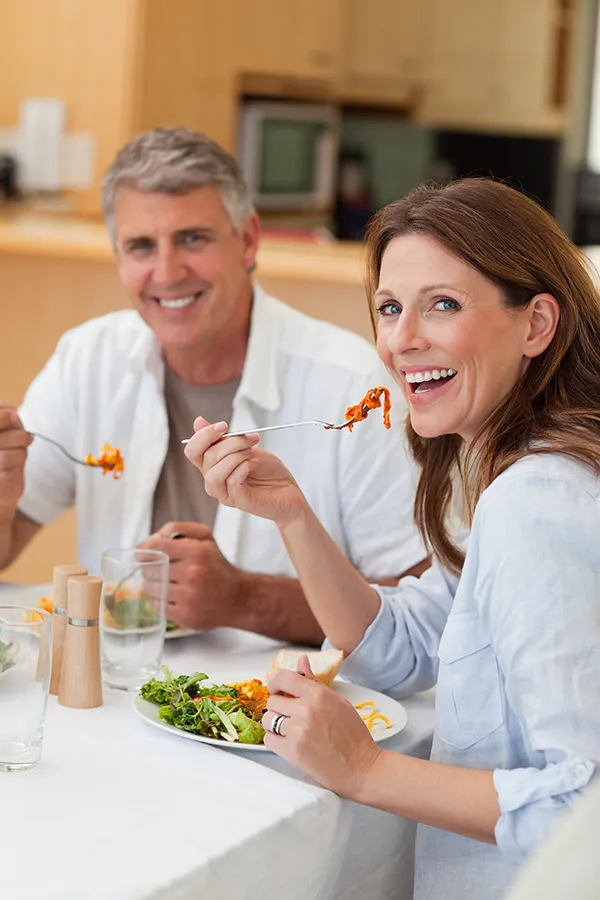 Microbiome-Testing-Treatment A couple sit and eat a healthy salad. Get microbiome testing from Dr. Stephanie King in Salt Lake City.