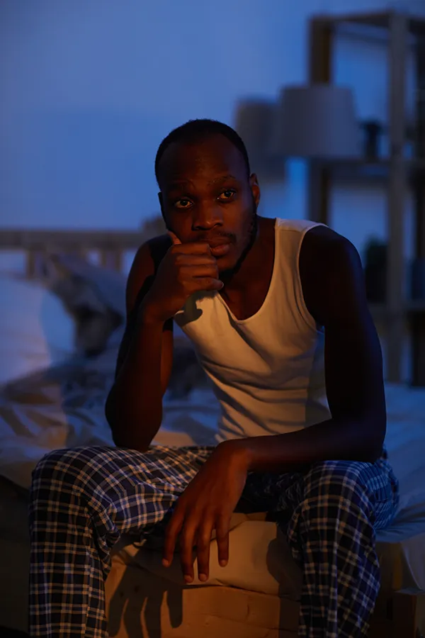 Sleep-Disorders-Treatment A man sits on the edge of his bed concerned that he can't sleep. Get treatment for sleep disorders from Dr. Stephanie King in Salt Lake City.