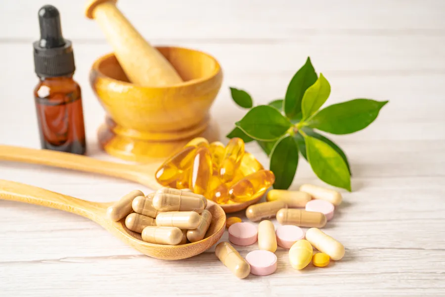 Supplements-Clinic A tableau of capsules, a vial of fluid, an herb, and a mortar and pestle. Get nutritional supplement consultation from Dr. Stephanie King in Salt Lake City.