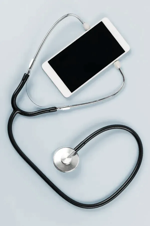 Telemedicine-Treatment A smartphone with a stethoscope attached to it, symbolizing Telemedicine treatment from Dr. Stephanie King in Salt Lake City.