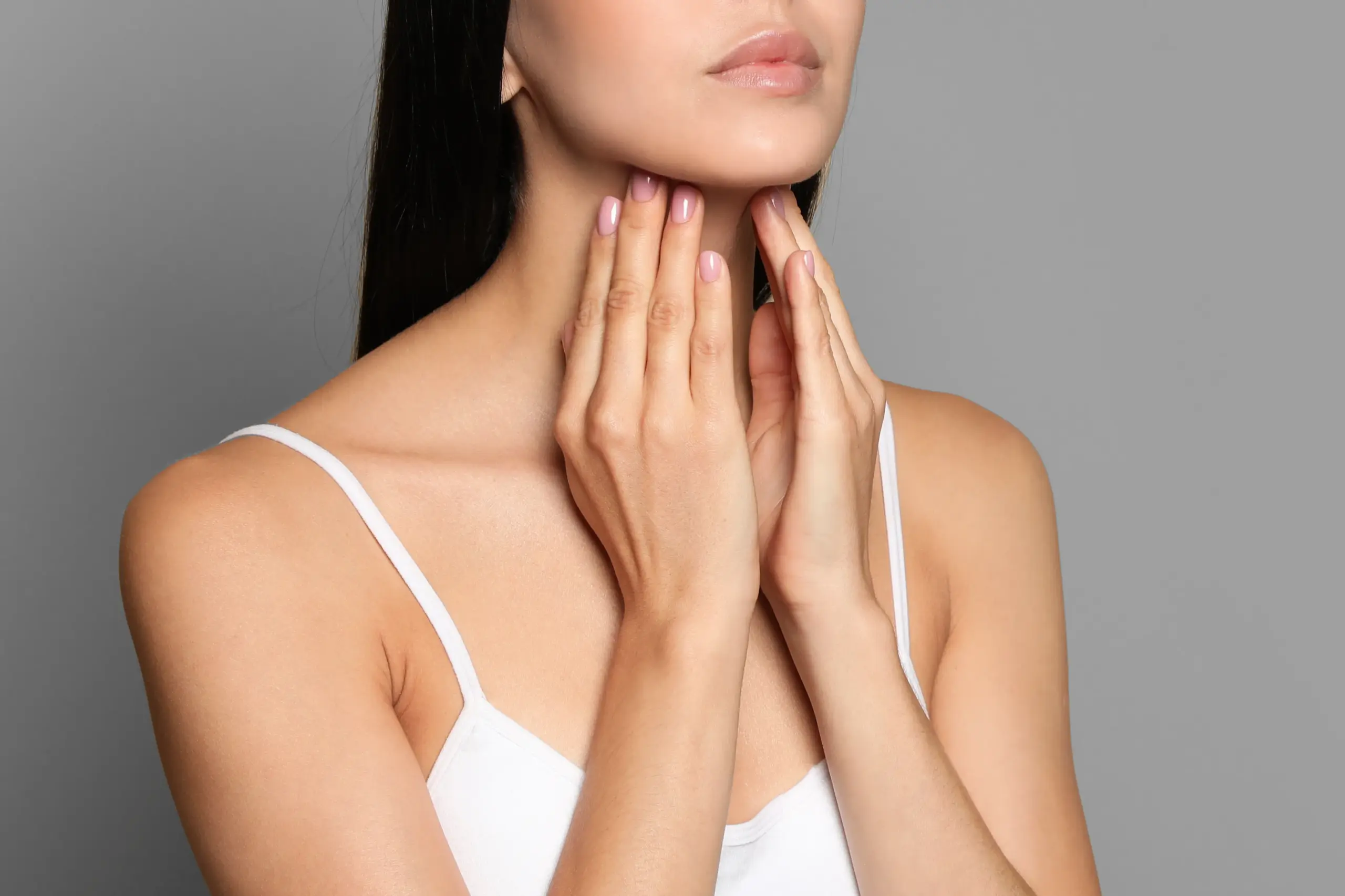 Thyroid-Doctor A woman in a white tank top touches her neck looking for signs of thyroid disorder. Get help for thyroid disorders from Dr. Stephanie King in Salt Lake City.