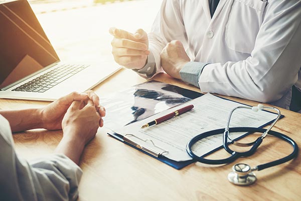 functional-medicine-doctor Functional medicine provider consulting with a patient, reviewing personalized health plan and test results in a clinical office setting. Schedule a functional medicine consultation with Dr. Stephanie King in Salt Lake City.