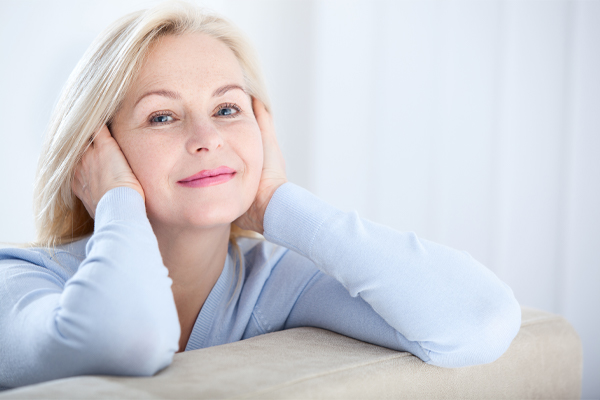 salt-lake-city-menopause-doctor Woman with light colored hair smiling comfortably at home, representing personalized care and support for women’s hormonal health and menopause management. Schedule a menopause consultation with Dr. Stephanie King in Salt Lake City.